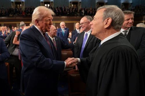 President Donald Trump greets Chief Justice John Roberts as he arrives to address a joint session of Congress at the Capitol in Washington last month